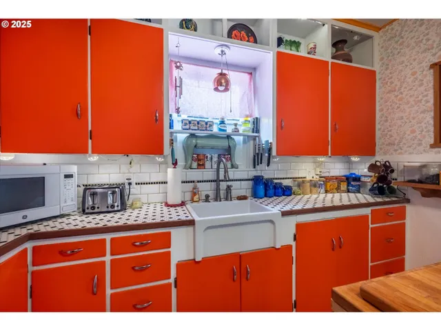 a kitchen with stainless steel appliances granite countertop a sink dishwasher stove and microwave