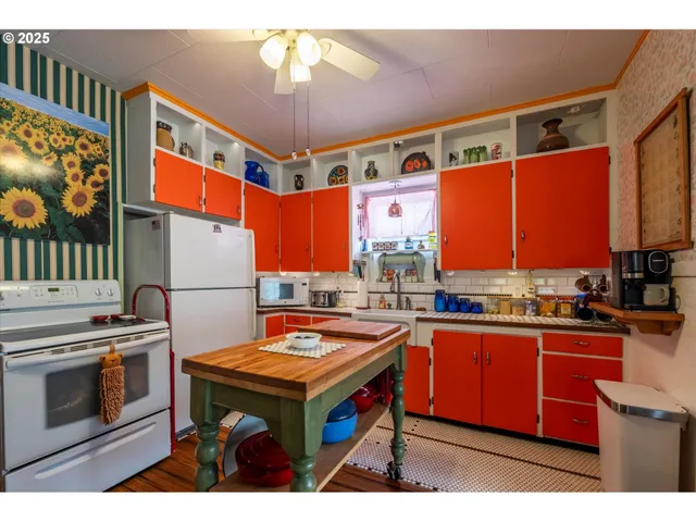 a kitchen with stainless steel appliances a stove a sink dishwasher and cabinets