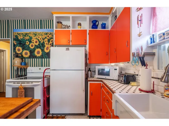 a kitchen with a refrigerator and a stove