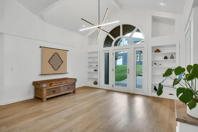a living room with fireplace furniture and a wooden floor
