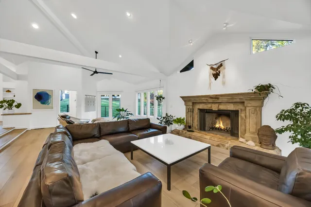 a kitchen with stainless steel appliances granite countertop a sink a stove and a wooden cabinets
