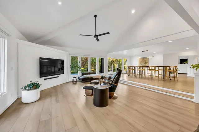 a view of a hallway with wooden floor and stairs