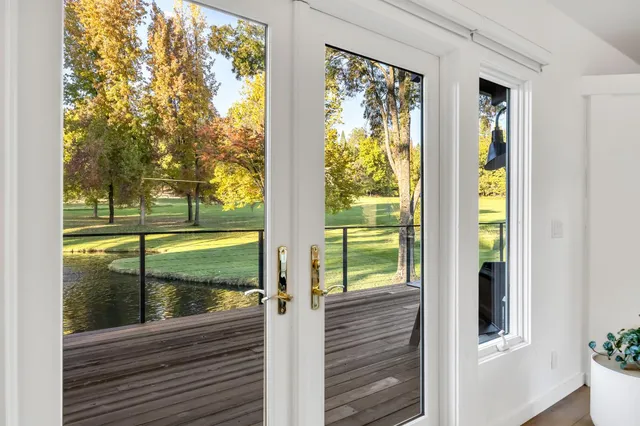 a bedroom with a bed window and mirror