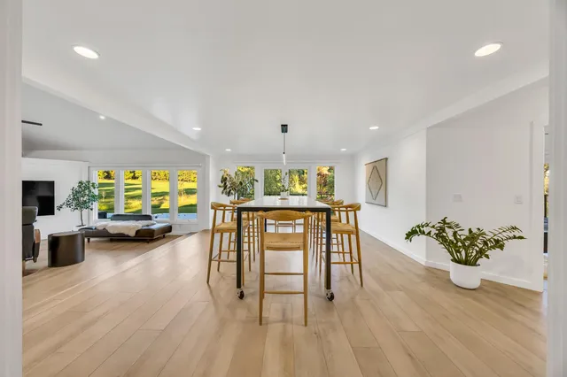 a bathroom with a granite countertop sink a large mirror and a window