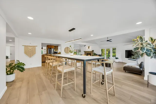 a bathroom with a granite countertop sink a mirror and a shower