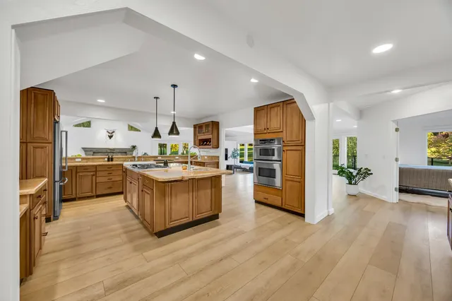 a spacious bedroom with a bed and a chandelier