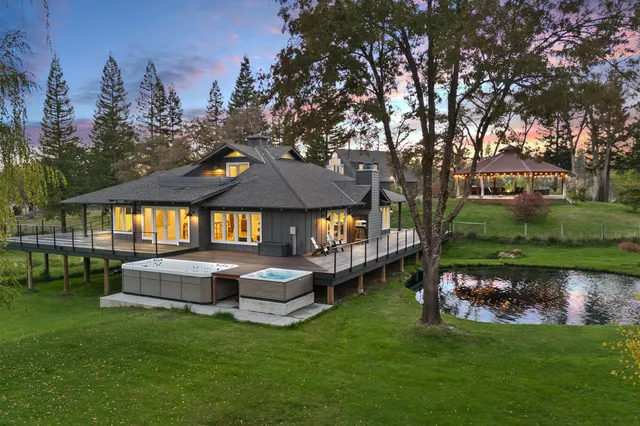 a view of a house with a yard and a garden