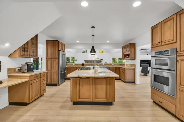 a spacious bedroom with a bed and a large window