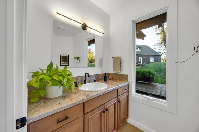 a view of a house with a chairs and table in a patio