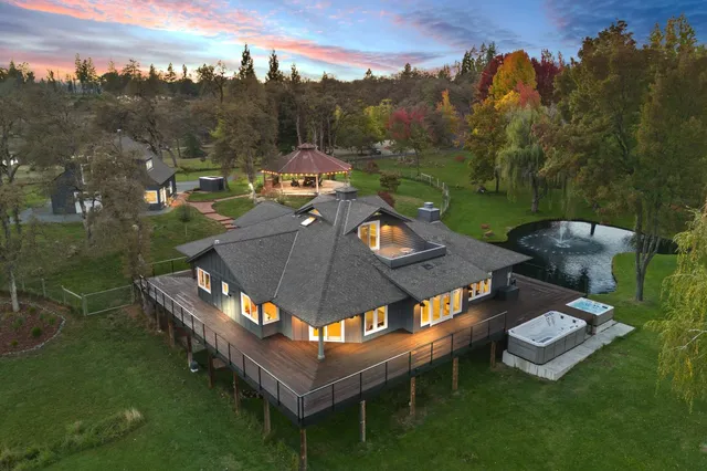a living room with furniture fireplace and a large window