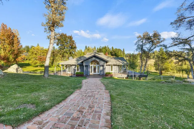 a living room with furniture and a view of kitchen