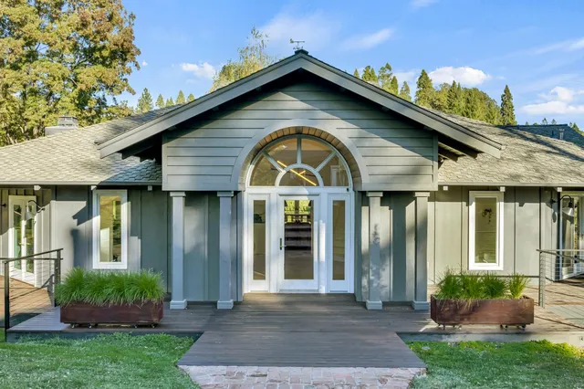 a living room with lots of furniture and view of kitchen