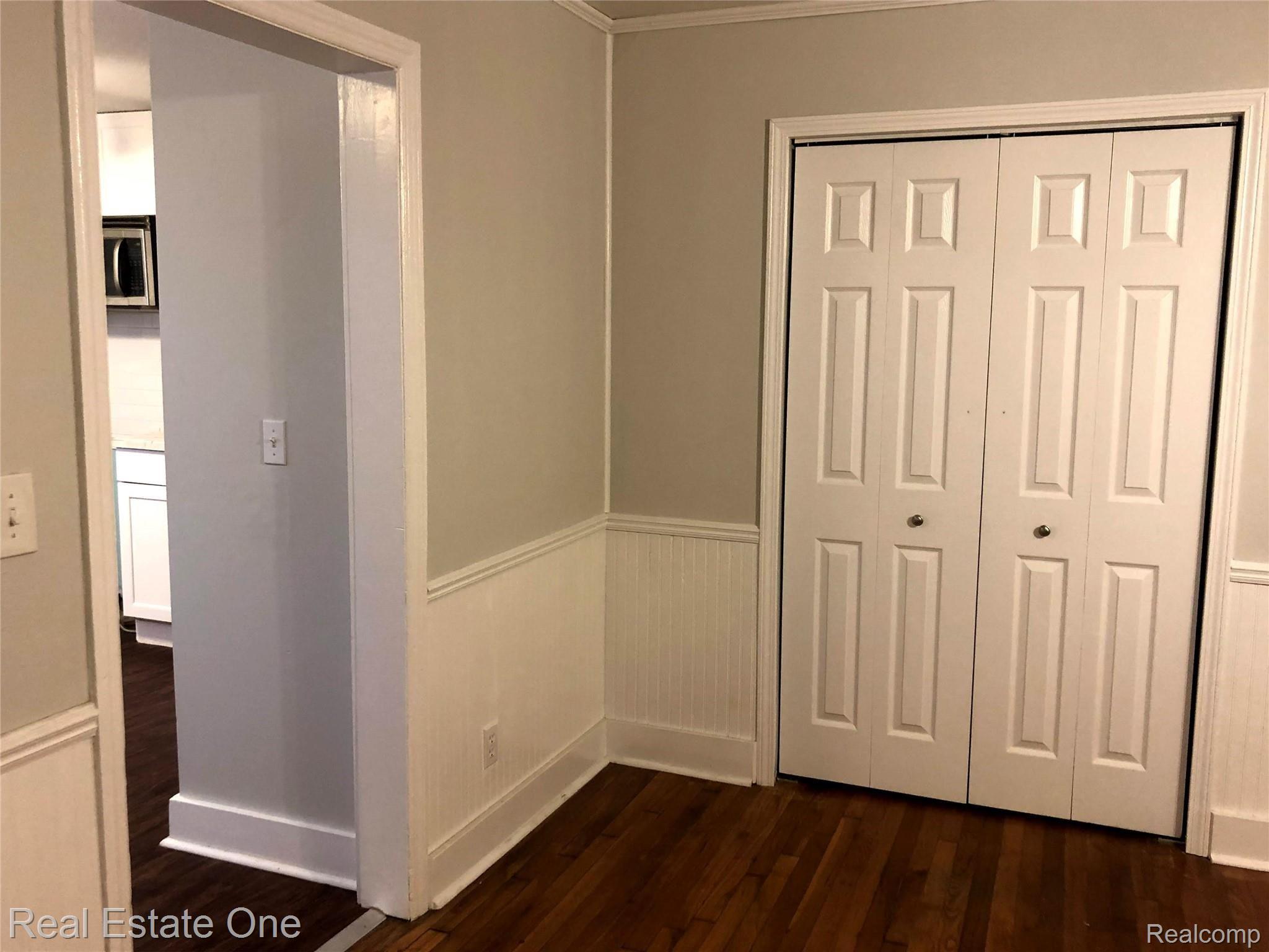 235 Millville Road Lapeer, MI 48446 - Photo 12 of 48 Front Room used as dining or living room. Original hardwood floors. Entrance to Kitchen on left. Large coat closet. Stairs and Family room to the right.