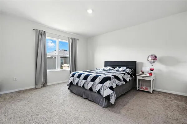 a bedroom with a bed and a table in it