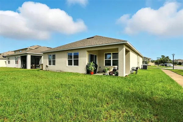 a front view of a house with a garden and yard