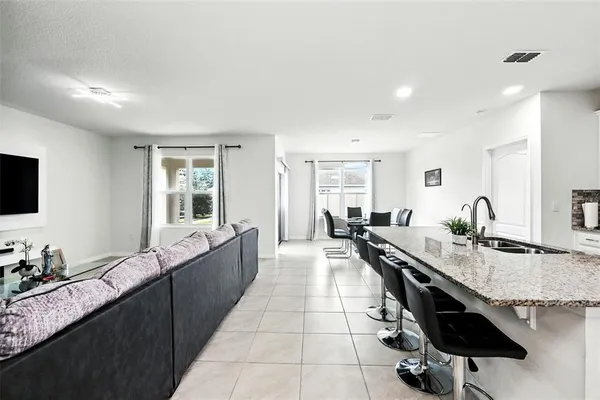 a kitchen with stainless steel appliances granite countertop a refrigerator and a stove top oven