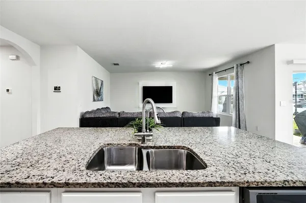 a kitchen with sink a stove and microwave