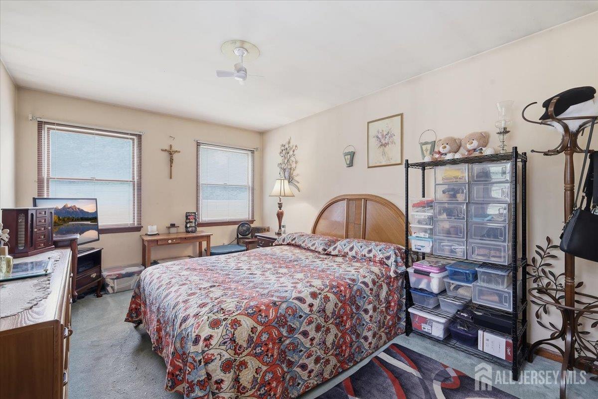 33 Ellison Road Somerset, NJ 08873 - Photo 12 of 38 a bedroom with a large bed and a chandelier