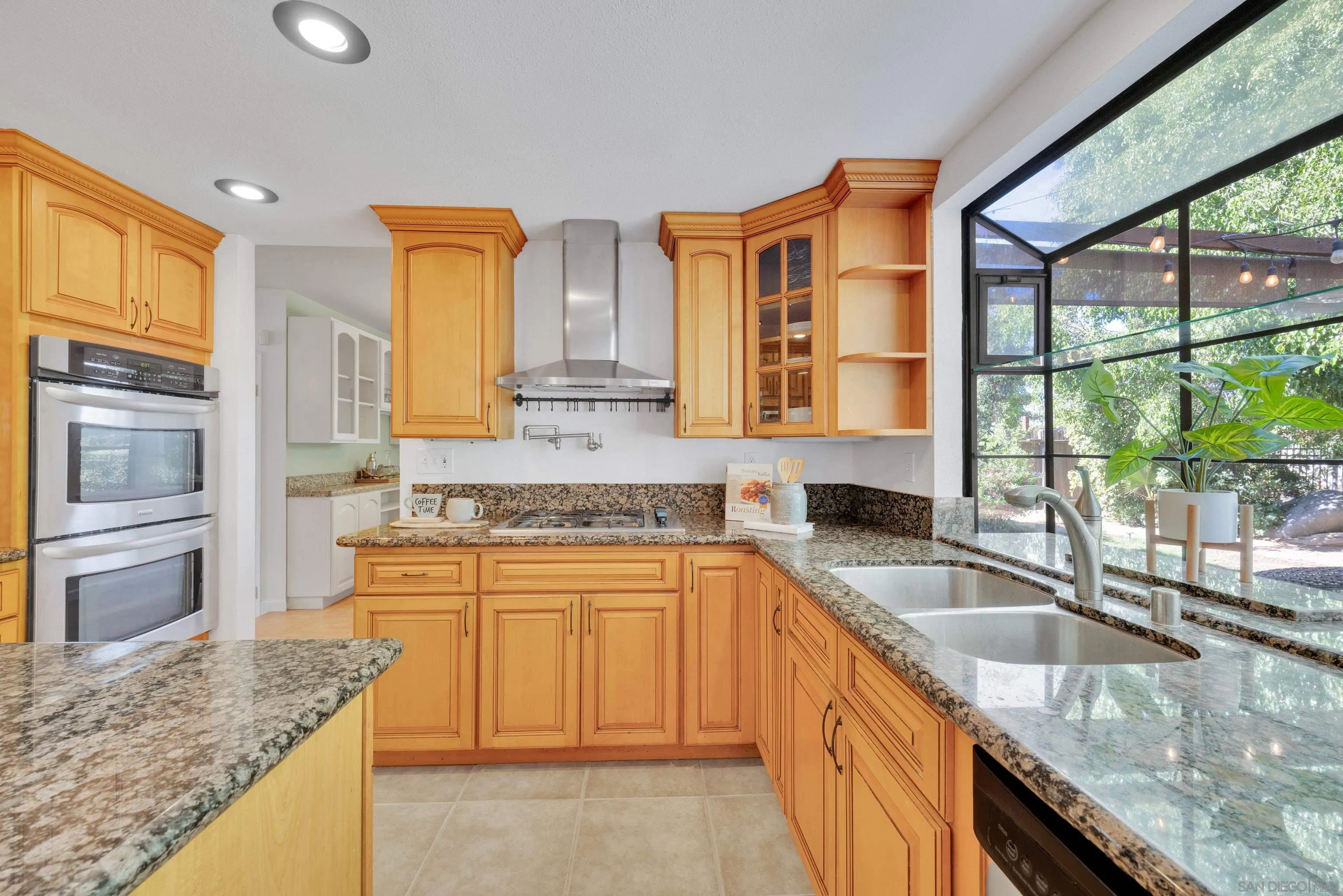 2010 Palsero Avenue Escondido, CA 92029 - Photo 14 of 58 a kitchen with stainless steel appliances granite countertop a sink and a granite counter tops