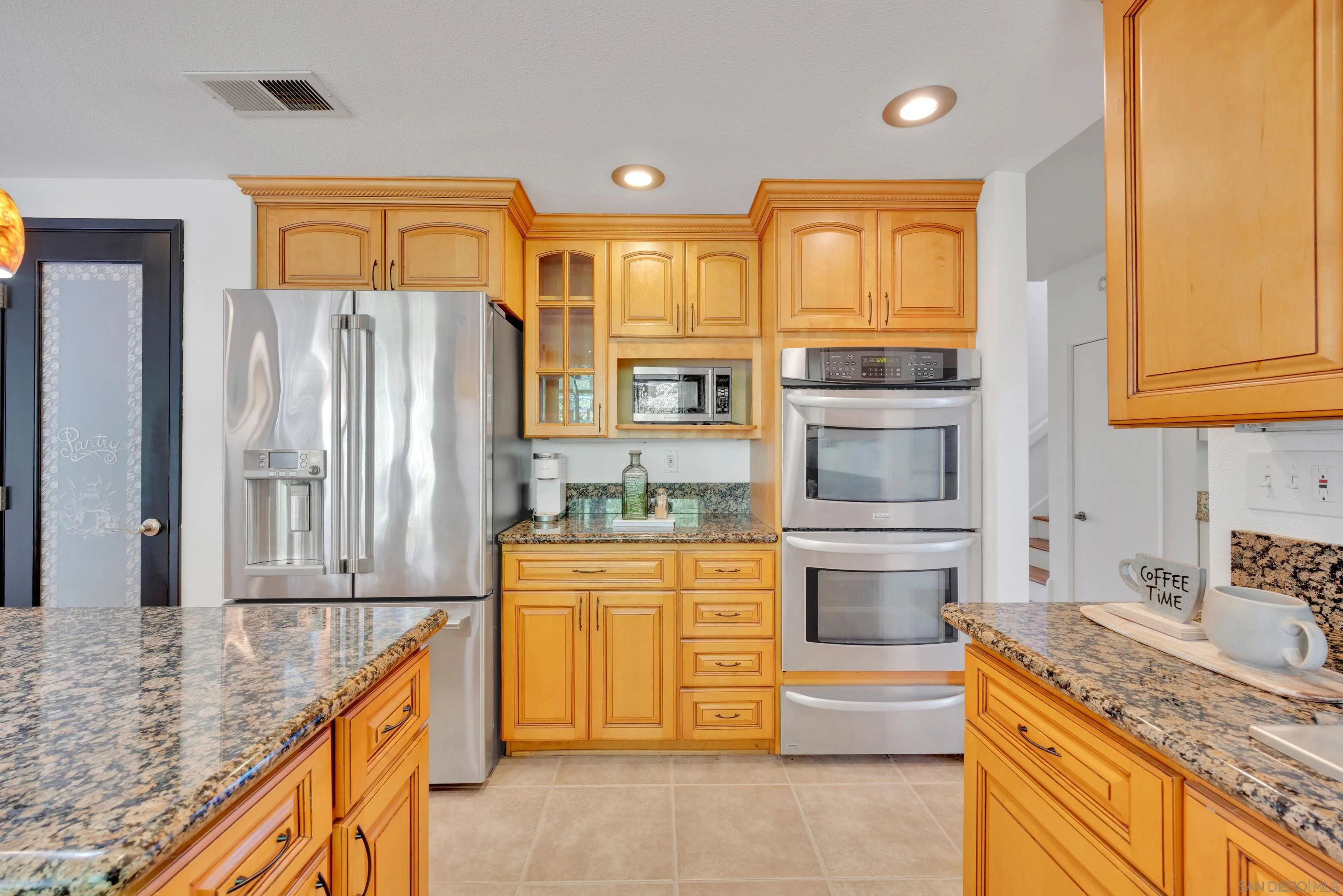 2010 Palsero Avenue Escondido, CA 92029 - Photo 15 of 58 a kitchen with stainless steel appliances granite countertop a refrigerator and a stove top oven