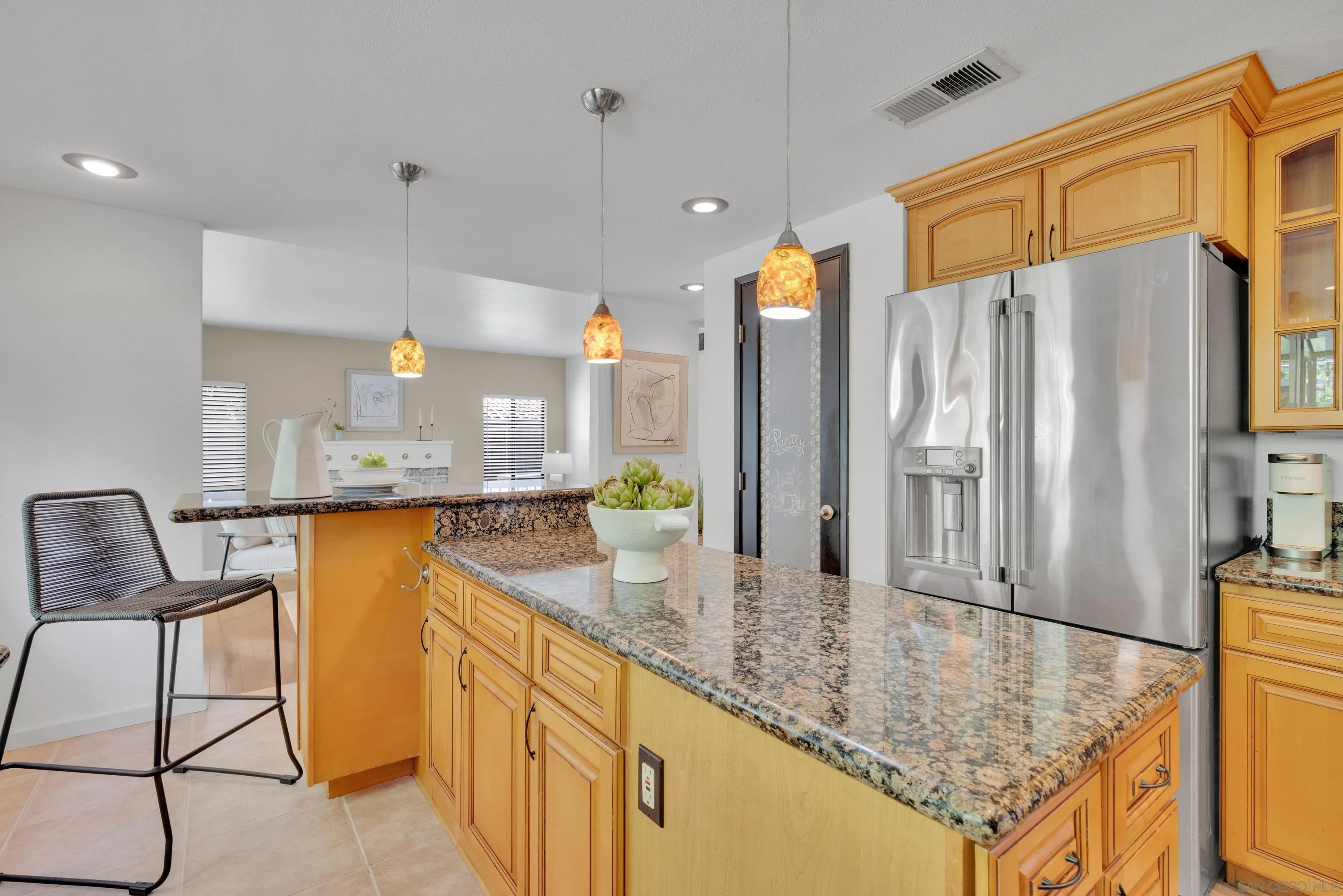 2010 Palsero Avenue Escondido, CA 92029 - Photo 17 of 58 a kitchen with stainless steel appliances granite countertop sink table and chairs