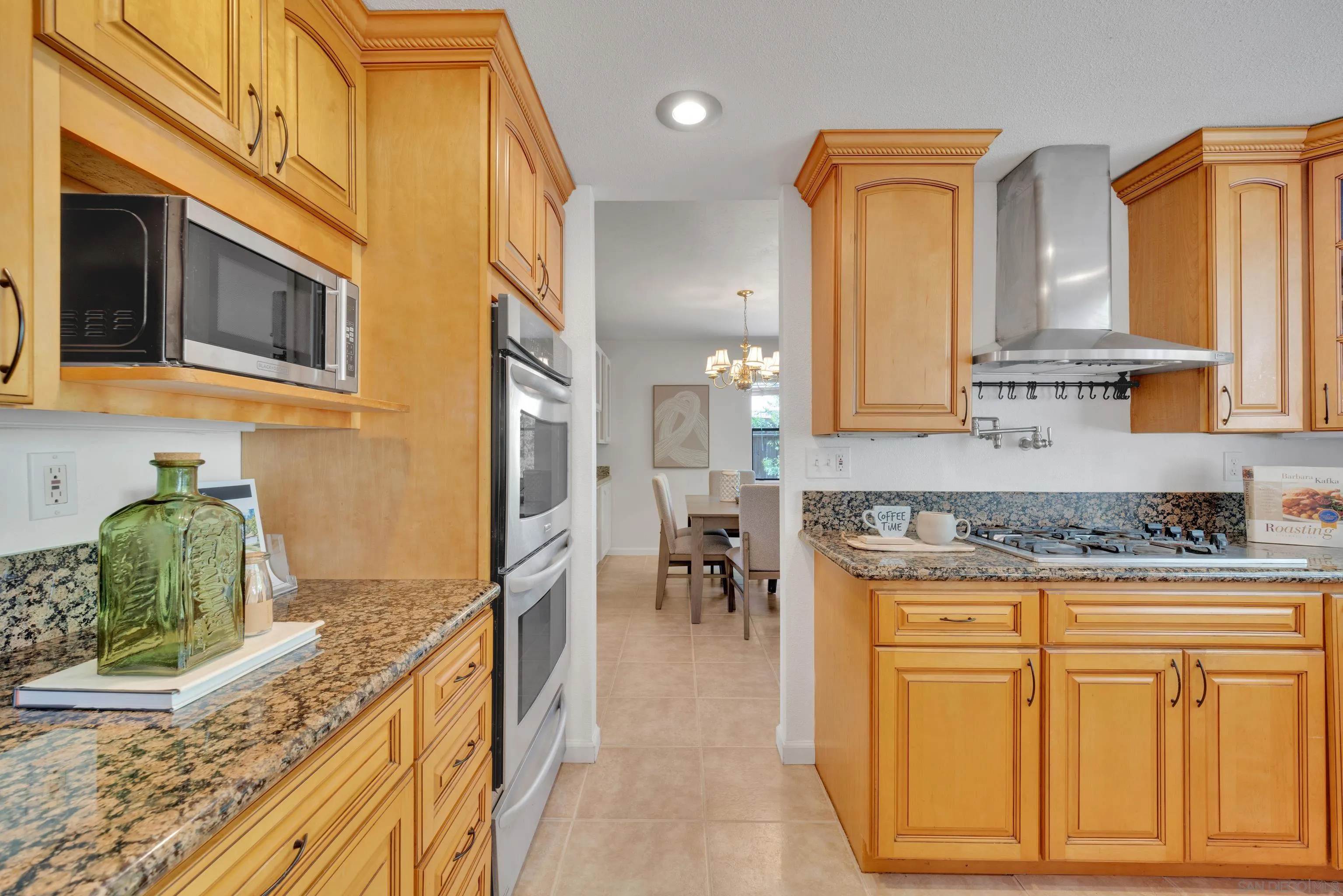 2010 Palsero Avenue Escondido, CA 92029 - Photo 4 of 58 a kitchen with stainless steel appliances granite countertop a stove a sink and a microwave