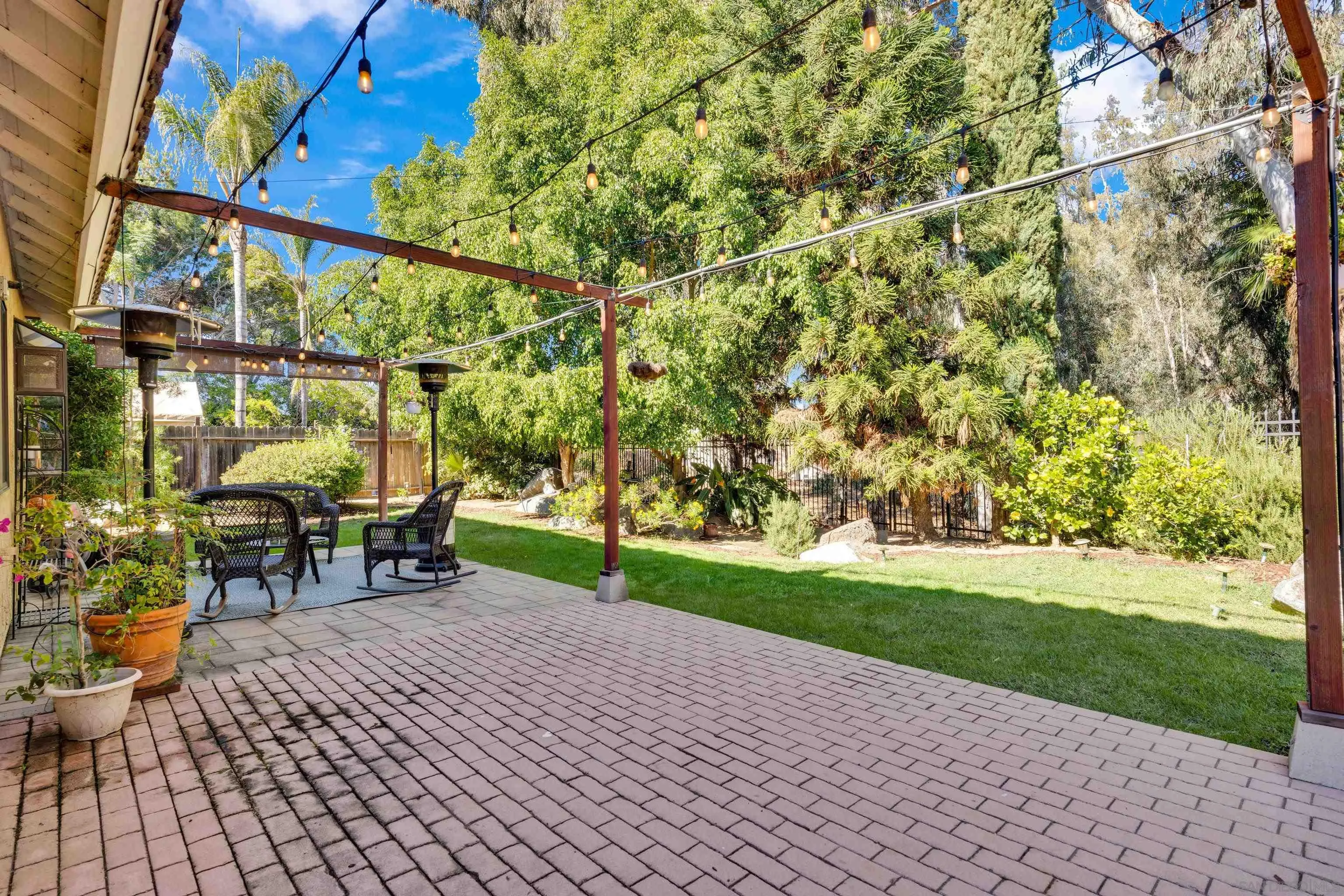 2010 Palsero Avenue Escondido, CA 92029 - Photo 48 of 58 a view of a patio with table and chairs potted plants and palm trees