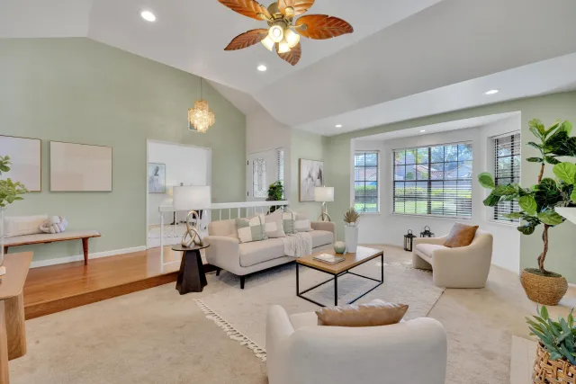 a living room with furniture a fireplace and a chandelier