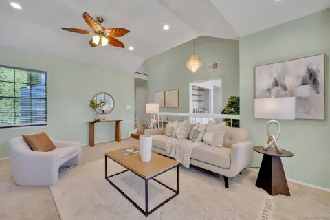a view of a dining room with furniture a chandelier and wooden floor