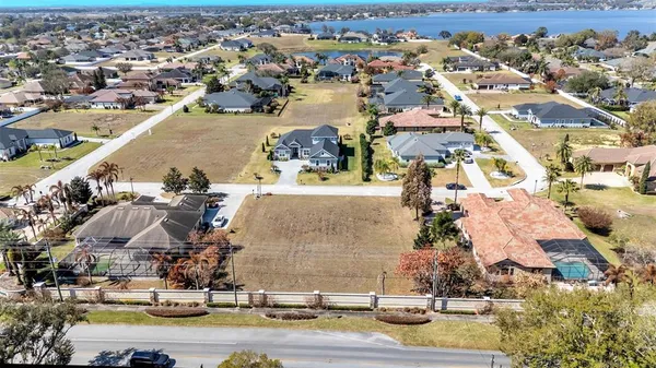 an aerial view of a house with a yard and large tree