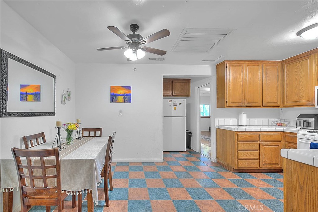 1042 Frontier Road Norco, CA 92860 - Photo 21 of 62 a view of a kitchen with a dining table and chairs