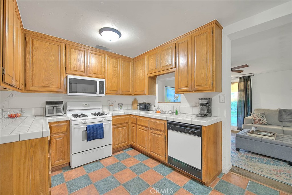 1042 Frontier Road Norco, CA 92860 - Photo 23 of 62 a kitchen with stainless steel appliances granite countertop a sink and cabinets