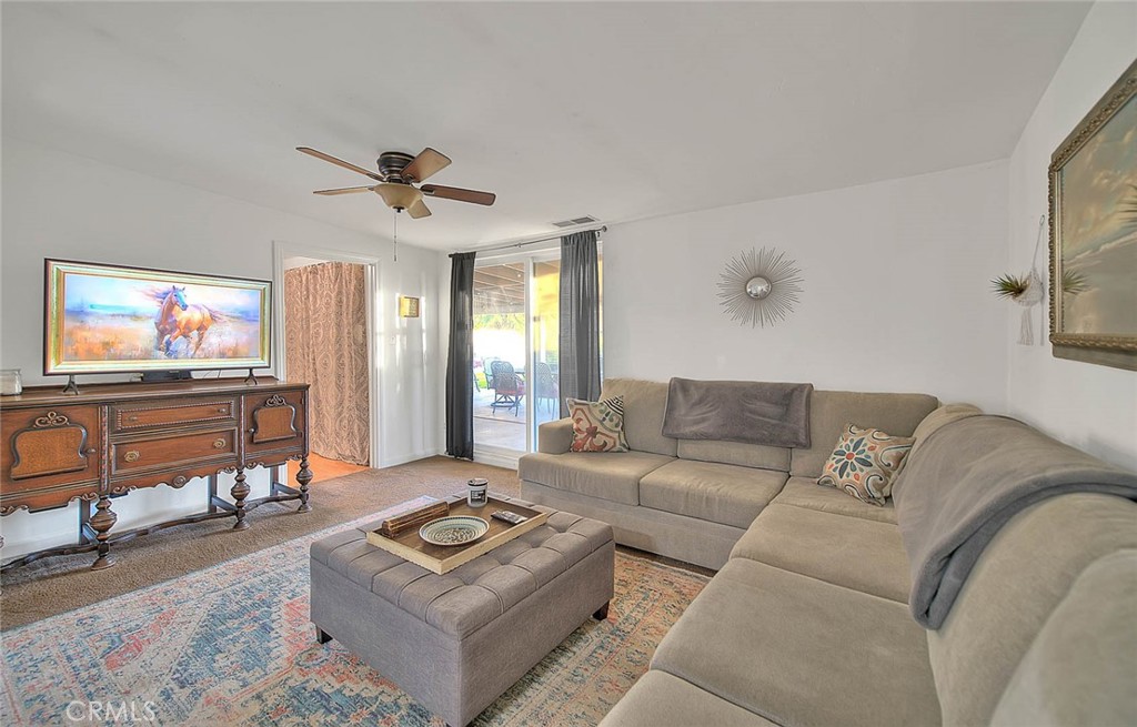 1042 Frontier Road Norco, CA 92860 - Photo 27 of 62 a living room with furniture a flat screen tv and a window