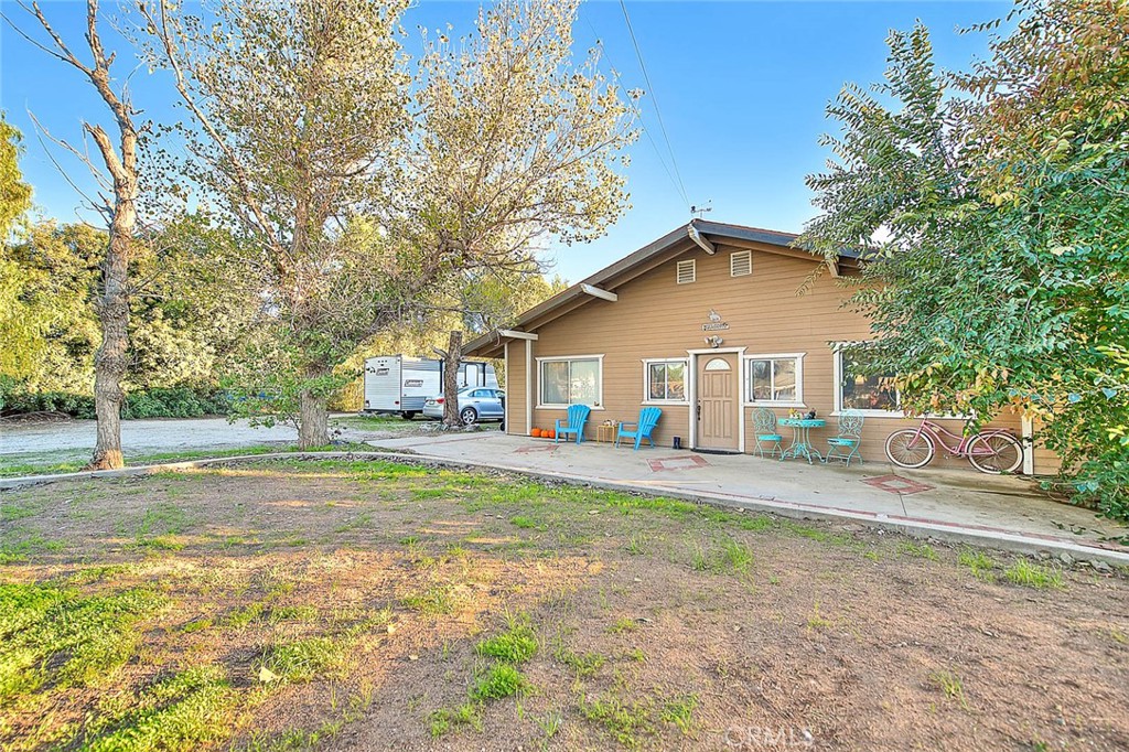 1042 Frontier Road Norco, CA 92860 - Photo 4 of 62 a front view of a house with a yard and garage