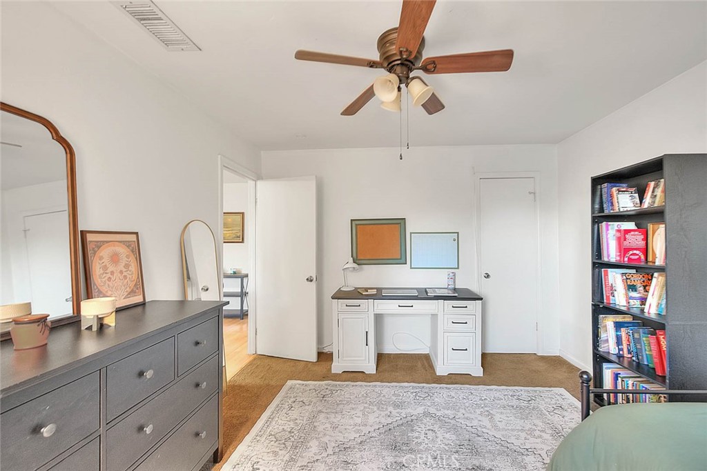 1042 Frontier Road Norco, CA 92860 - Photo 43 of 62 a spacious bedroom with a bed dresser and a window