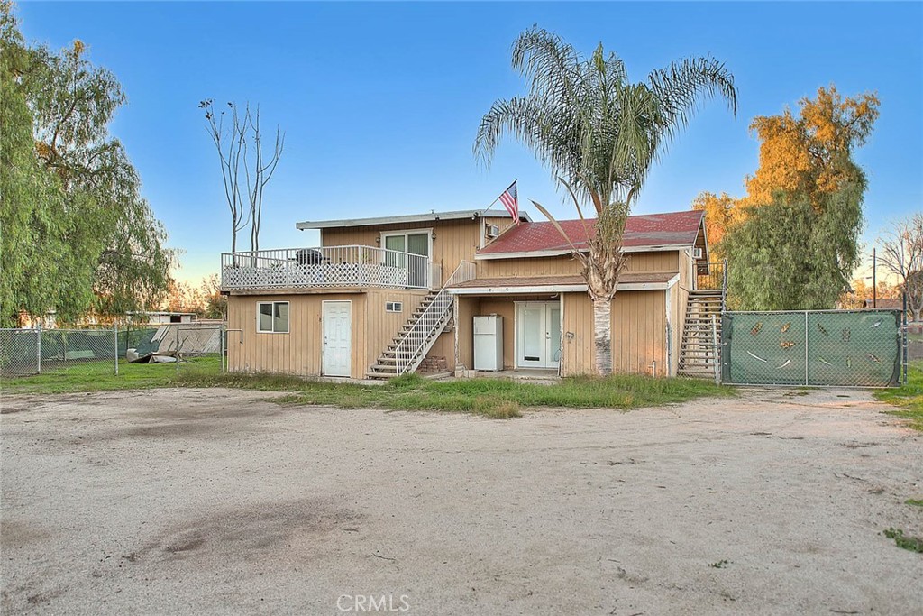 1042 Frontier Road Norco, CA 92860 - Photo 58 of 62 a yellow house with trees in front of it