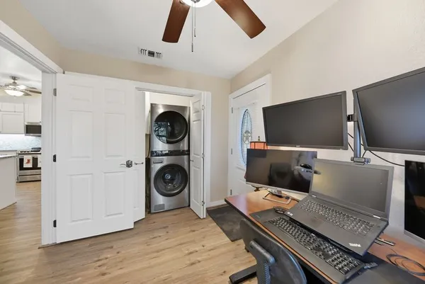 a view of a workspace with furniture and a window