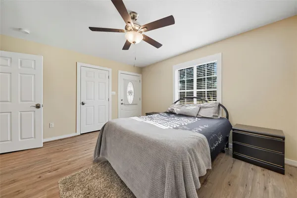a bedroom with a bed and a chandelier
