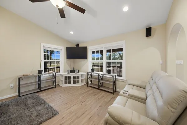 a living room with furniture and a flat screen tv