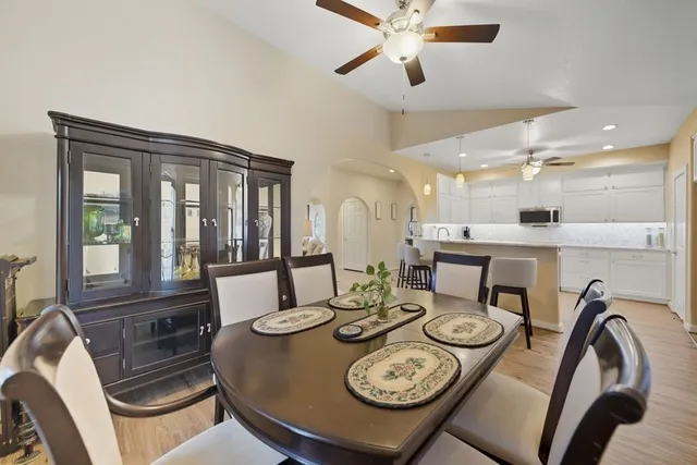 a view of a dining room with furniture and a chandelier