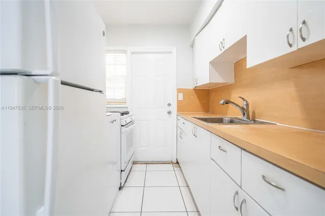 a bathroom with a granite countertop sink a mirror and shower