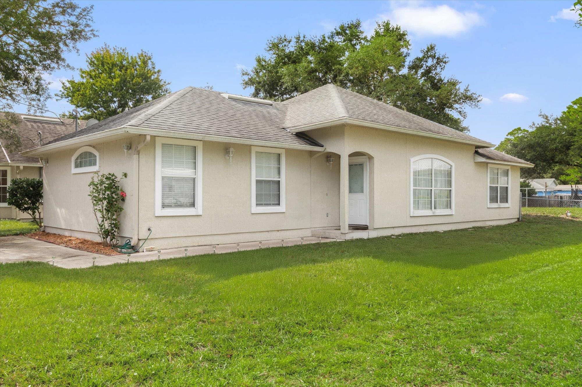 3372 4th Street Elkton, FL 32033 - Photo 25 of 36 a front view of a house with a garden