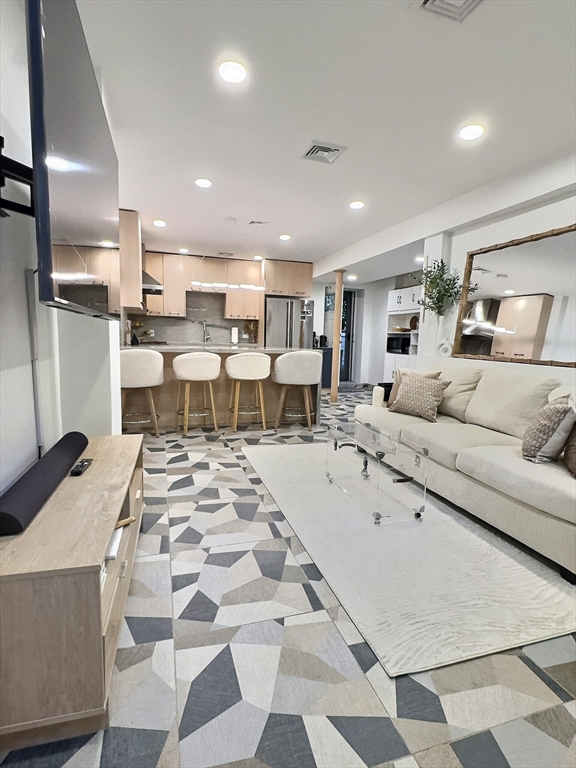 187 London Street, Unit 1 Boston, MA 02128 - Photo 18 of 26 a living room with lots of furniture and view of kitchen