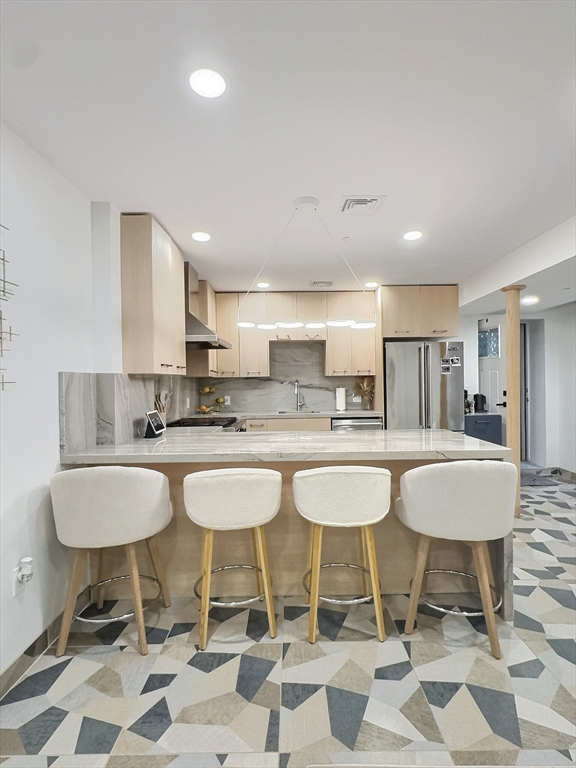 187 London Street, Unit 1 Boston, MA 02128 - Photo 20 of 26 a kitchen with a dining table chairs and white cabinets