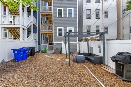 187 London Street, Unit 1 Boston, MA 02128 - Photo 26 of 26 a view of a patio with couches chairs and wooden floor