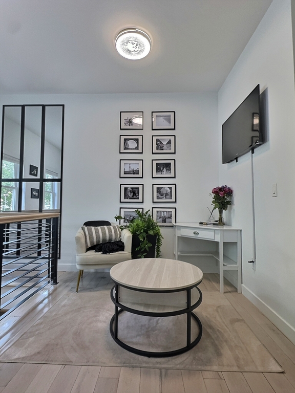 187 London Street, Unit 1 Boston, MA 02128 - Photo 3 of 26 a living room with furniture and a potted plant