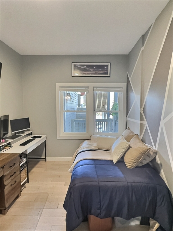 187 London Street, Unit 1 Boston, MA 02128 - Photo 9 of 26 a bedroom with a bed and a window