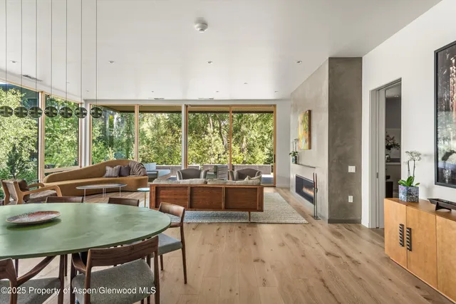 a view of a dining room with furniture window and wooden floor