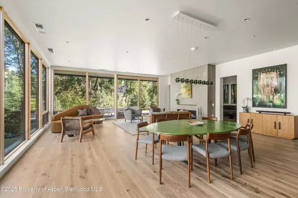 a dining room with furniture window and wooden floor