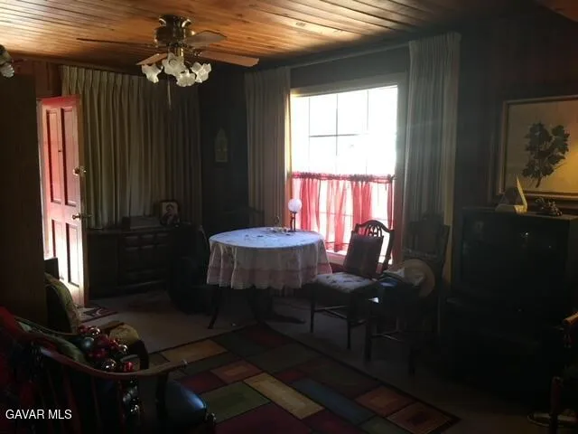 a table and chairs in a room next to a window